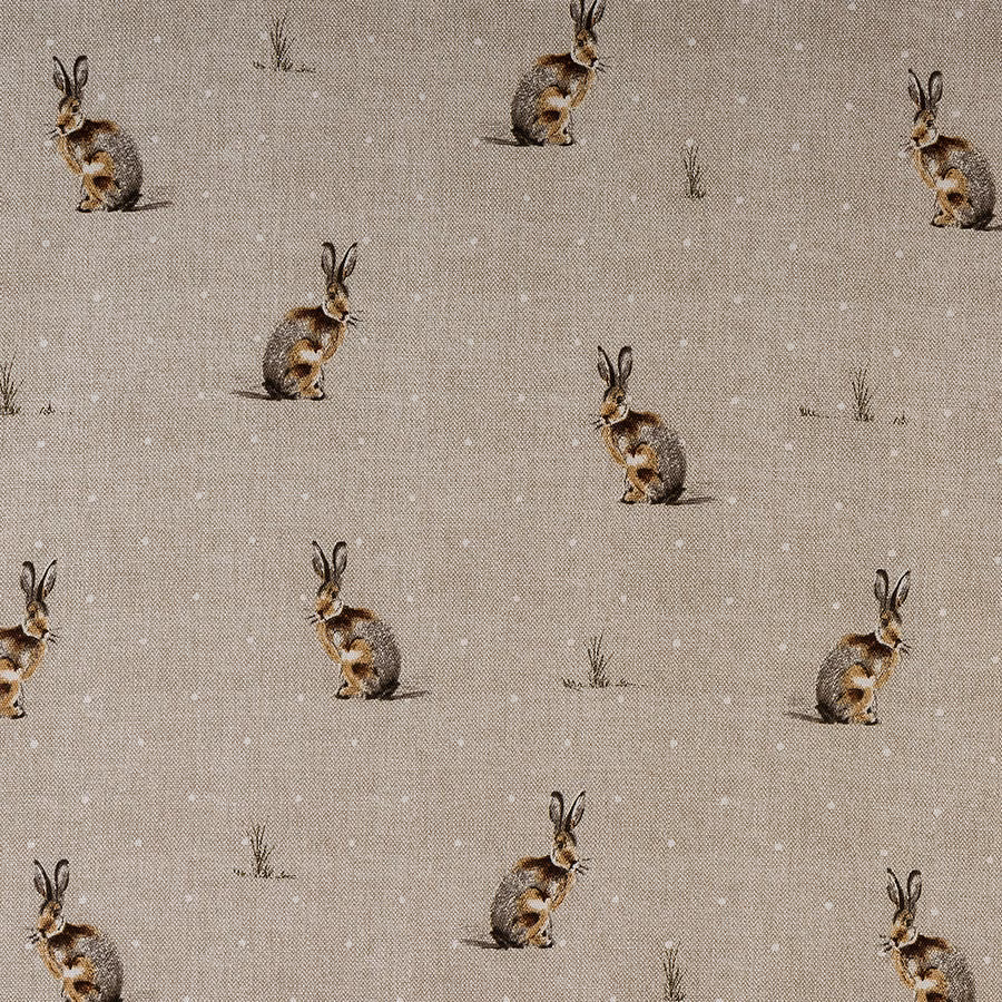 Beige PVC table cover with small rabbit motifs and scattered grass tufts