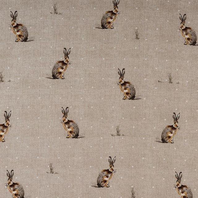Beige PVC table cover with small rabbit motifs and scattered grass tufts