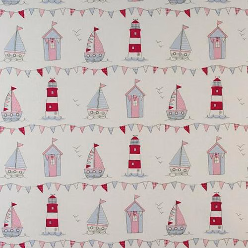 Pink seaside print with sailboats, lighthouses and bunting on a pale ground