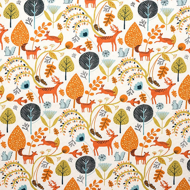 Cream cotton fabric with burnt orange woodland animals, stylised trees and teal accents