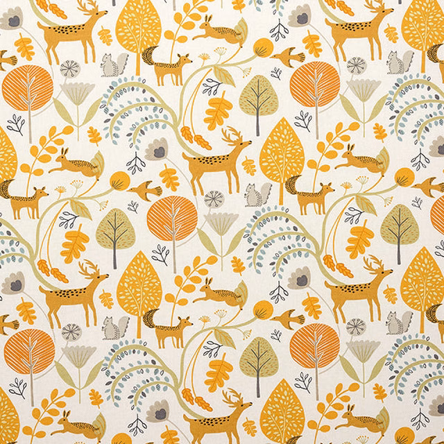 Ochre woodland deer and leaves print on a cream cotton ground