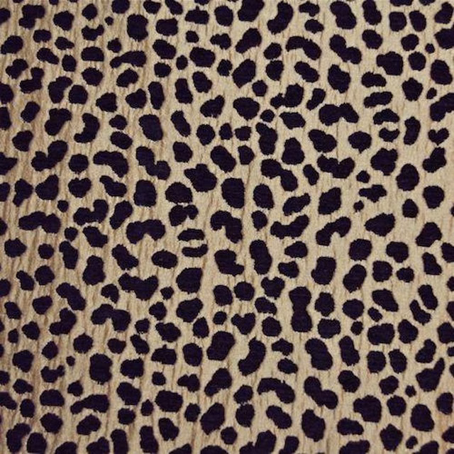 Leopard-style bronze beige fabric with dark brown-black spots and textured weave
