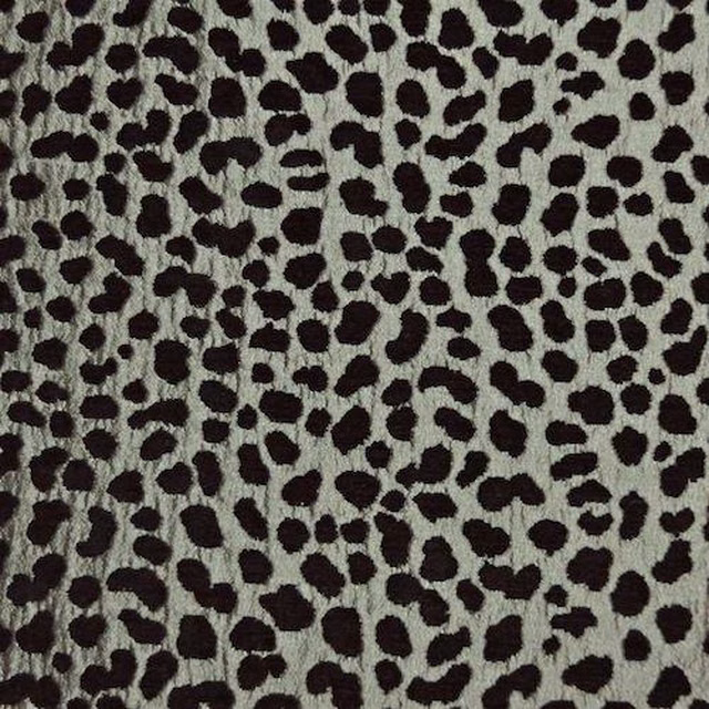 Silver-grey fabric swatch with irregular dark leopard-style spots