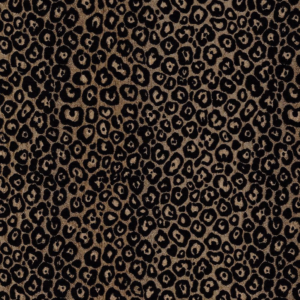 Close-up of bronze leopard spots on a black woven fabric swatch