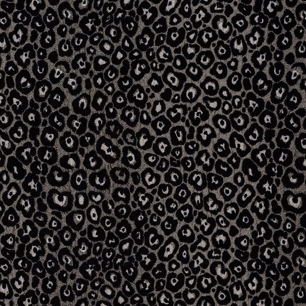 Close-up of black and smoky silver animal-print fabric with small irregular spots