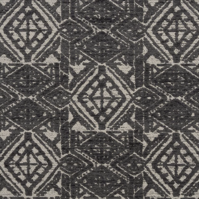 Close-up of slate-grey geometric diamond fabric on a stone ground