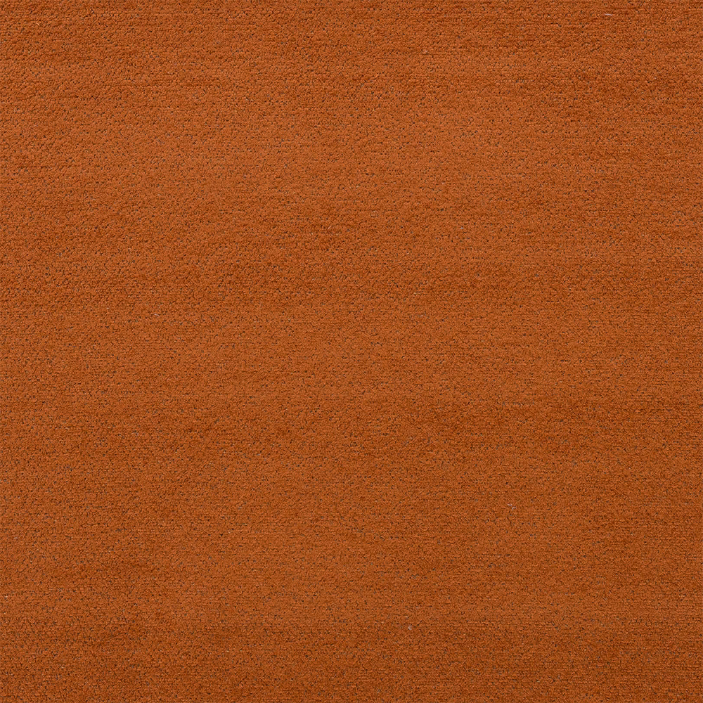 Close-up of a warm rust terracotta plain upholstery fabric with a softly textured surface