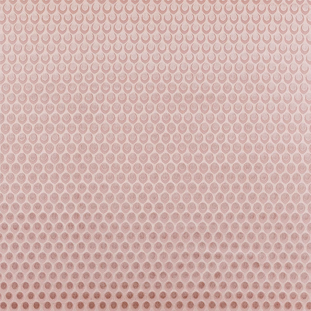Soft blush pink fabric with a small repeating damask pattern and mottled texture
