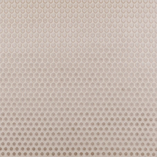 Pale antique beige fabric with small repeating circular motif and soft woven texture