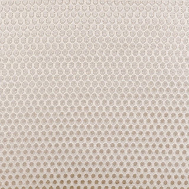Swatch of beige circular motif fabric on a warm natural ground