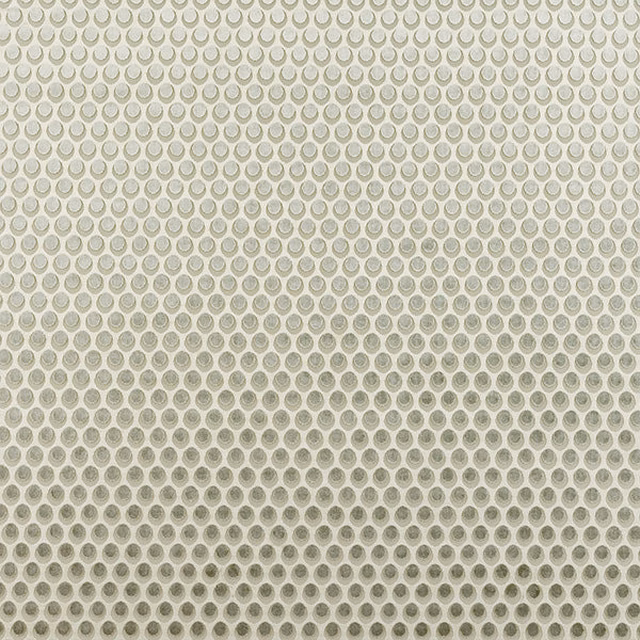 Pale olive geometric fabric with small circular motif on a light ground