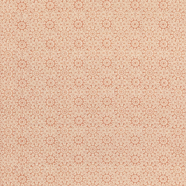 Warm terracotta and cream cotton-linen fabric with repeating tiny rosettes and geometric motifs