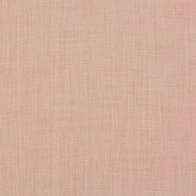 Close-up of warm blush pink linen with a fine, irregular woven texture