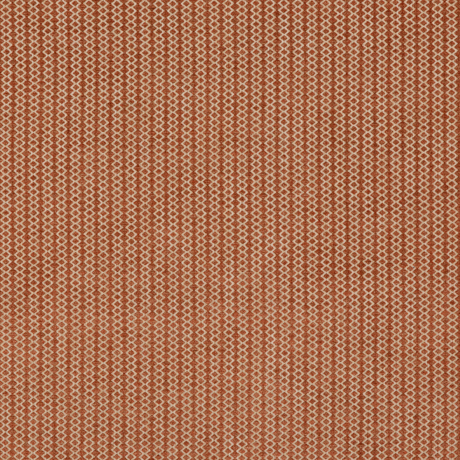 Muted tomato-red woven fabric with tiny cream diamond motifs