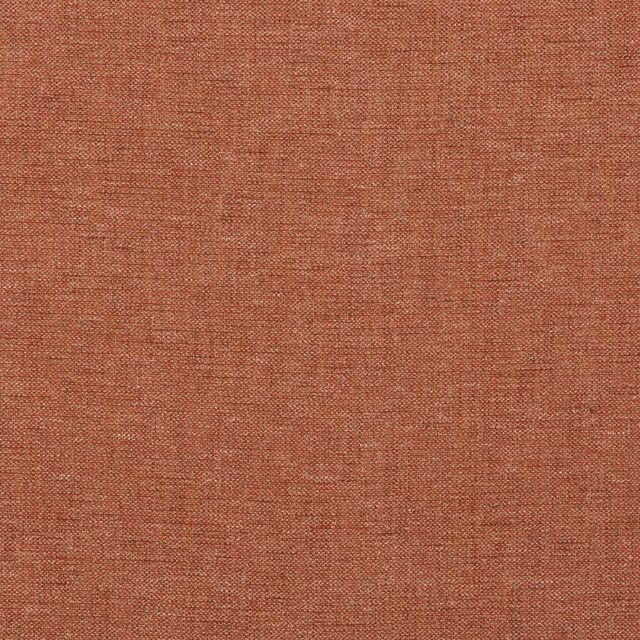 Close-up of warm tomato-red fabric with a fine irregular woven texture
