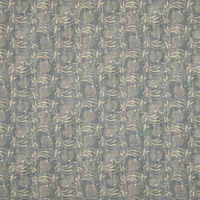 Muted denim-blue fabric with cream botanical pomegranate motifs and a softly textured ground