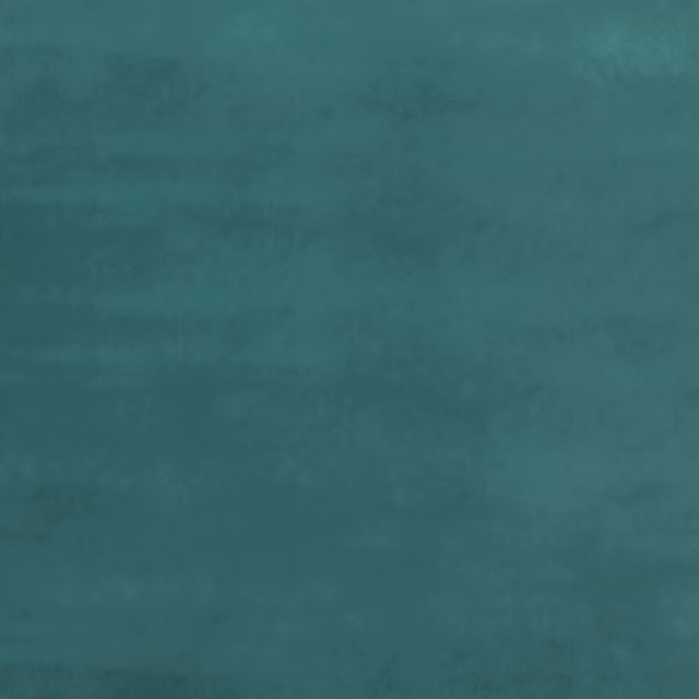Close-up of jade teal velvet with softly shifting nap and cloudy tonal depth
