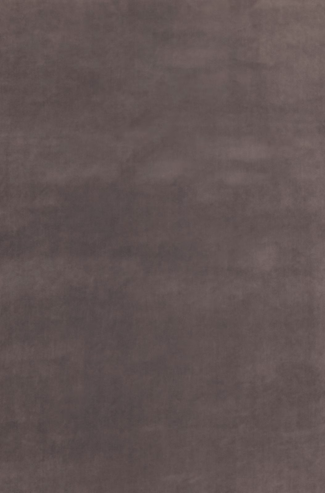 Close-up of cool silver-grey velvet with softly mottled nap and subtle sheen
