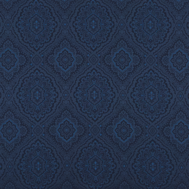 Deep indigo damask fabric with repeating blue medallions and intricate tonal woven detail