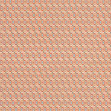 Dense geometric fabric in brick red, ochre, cream and muted green