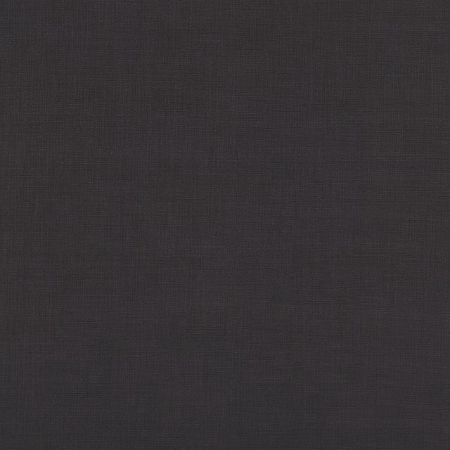 Dark indigo textile showing a subtle charcoal crosshatch weave and softly varied surface