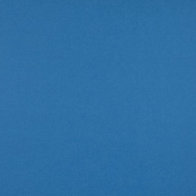 Close-up of finely textured, muted mid-blue woven fabric with a soft cloudy surface