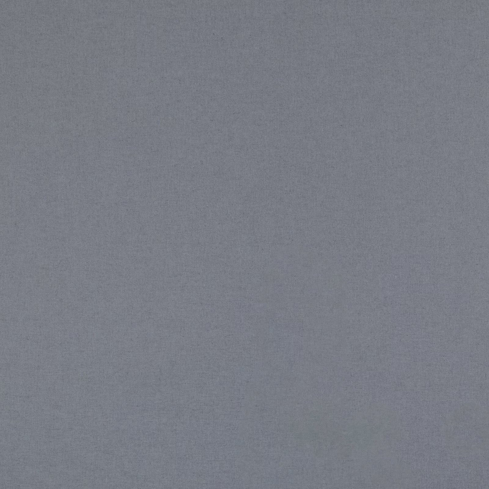 Close-up of muted denim-blue woven surface with softly flecked texture