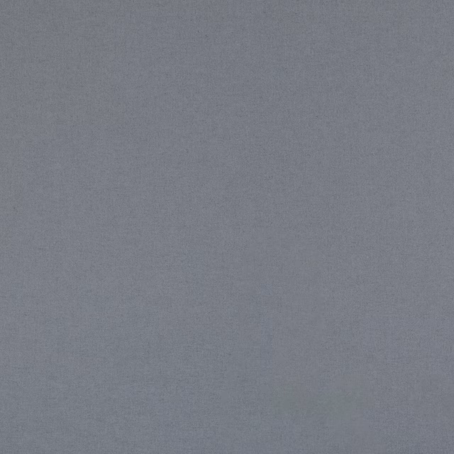 Close-up of muted denim-blue woven surface with softly flecked texture