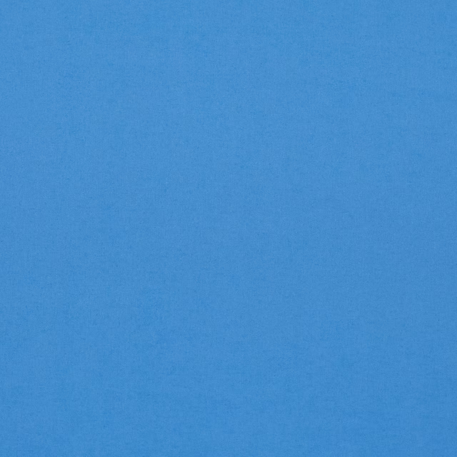 Close view of cool sky blue linen-blend cloth with subtle plain-weave texture