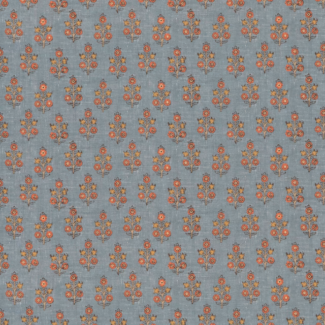 Muted denim-blue fabric with small coral and ochre floral sprigs and woven texture
