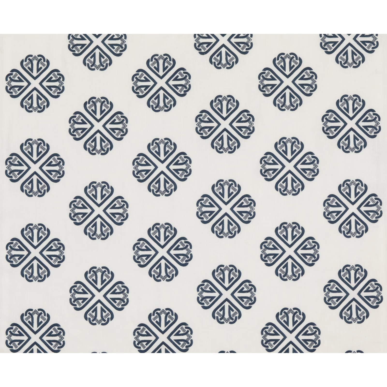 Cool indigo ornamental medallions repeating across a pale ivory textile ground