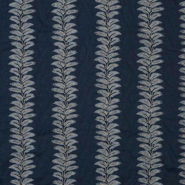 Deep indigo botanical fabric with repeating pale blue-grey leafy stems