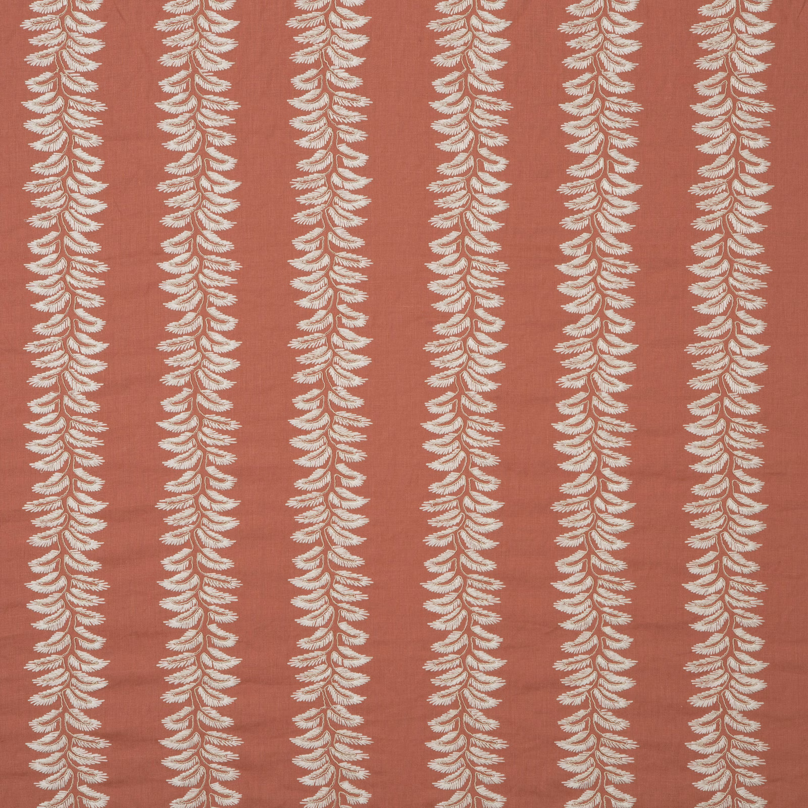 Muted coral terracotta fabric with repeating cream fern stripes and softly textured ground