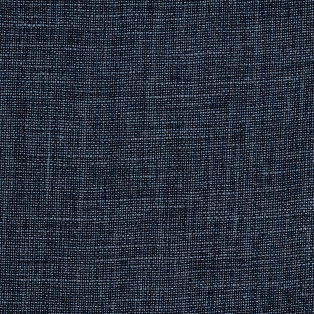 Close-up of weathered charcoal linen with an irregular pale-flecked woven texture