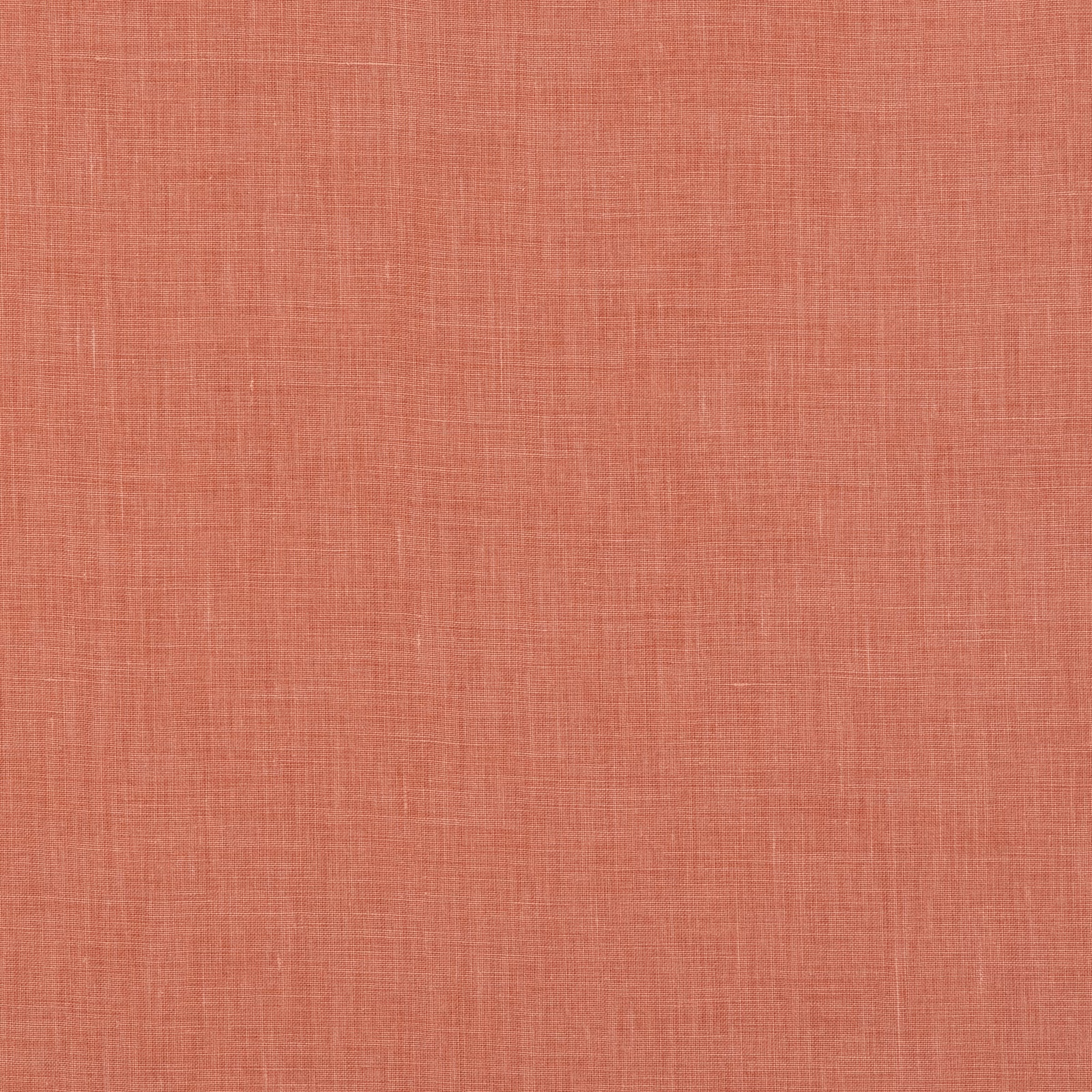 Close-up of muted coral linen with a fine, irregular crosshatch weave
