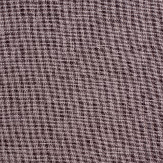 Close-up of muted mauve taupe linen with a weathered crosshatched weave