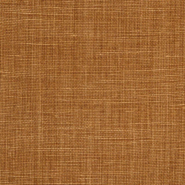 Warm ochre linen showing a coarse, subtly slubbed plain weave
