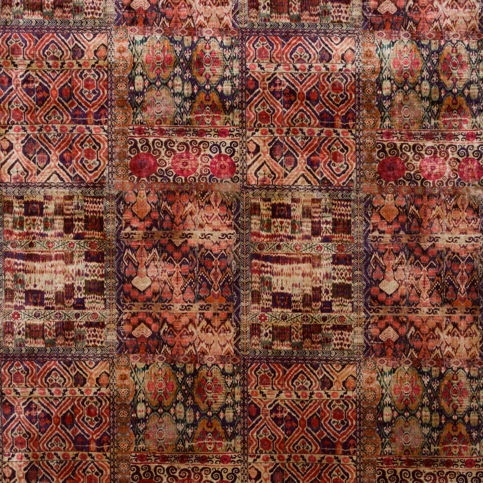 Close view of Rio Magenta velvet with burgundy, rose and olive geometric panels