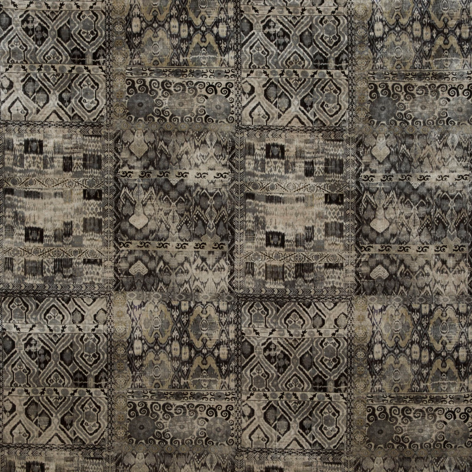Charcoal velvet with taupe and olive geometric panels, scrolling motifs and ornate borders