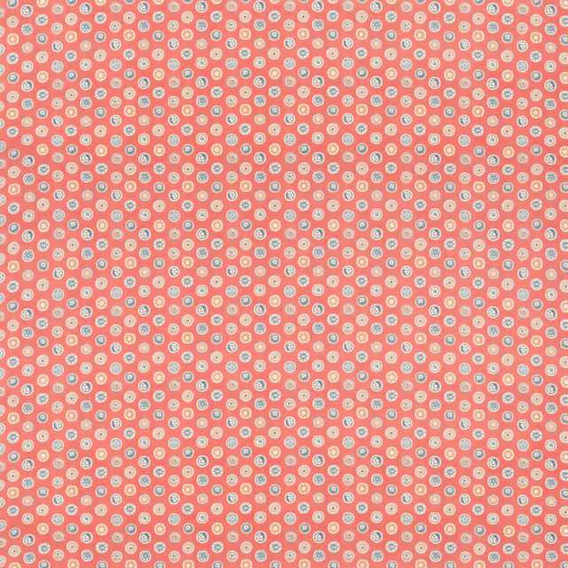 Dusty old-red cotton with dense cream button motifs in a small repeat
