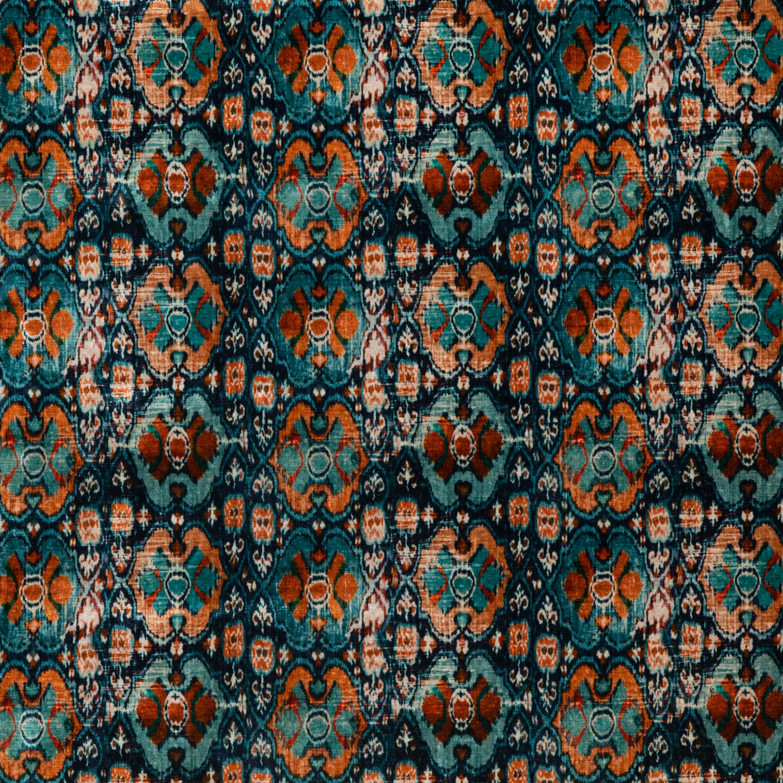 Deep teal velvet with rust, coral and cream geometric medallions in a dense repeating lattice