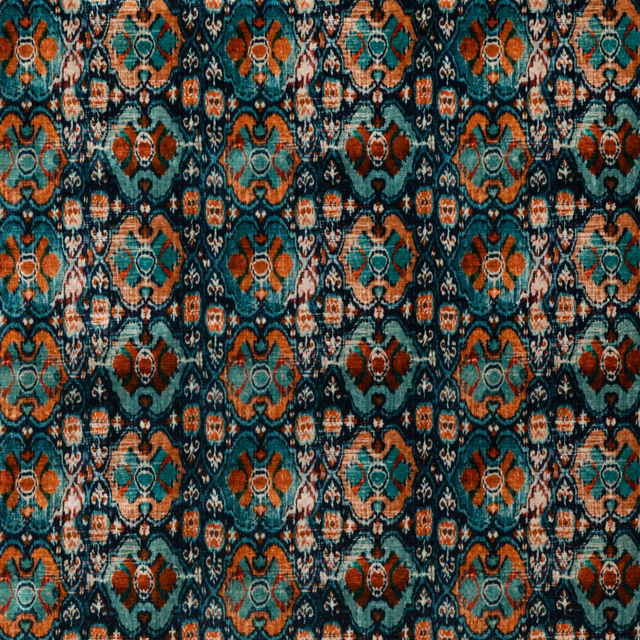 Deep teal velvet with rust, coral and cream geometric medallions in a dense repeating lattice