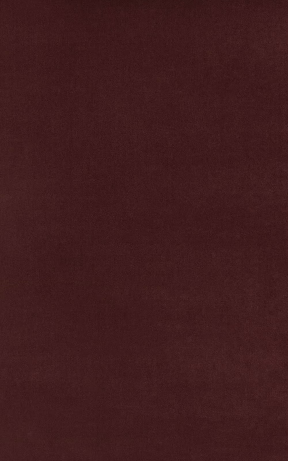 Close-up of deep damson burgundy velvet with a soft, subtly varied nap