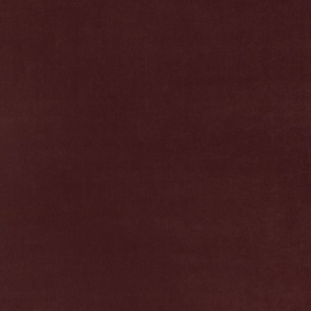 Close-up of deep damson burgundy velvet with a soft, subtly varied nap