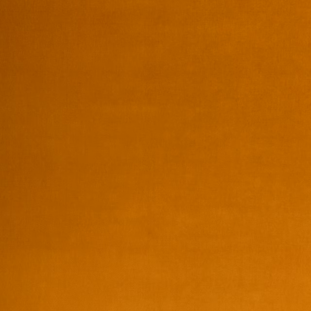 Close-up of warm ochre velvet with subtle directional pile shading