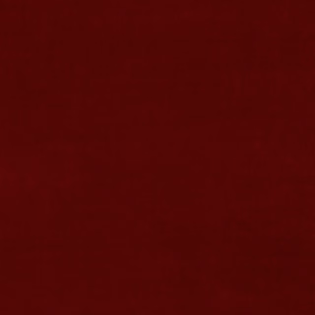 Deep Tuscan red velvet with subtle nap variation and a softly shaded surface