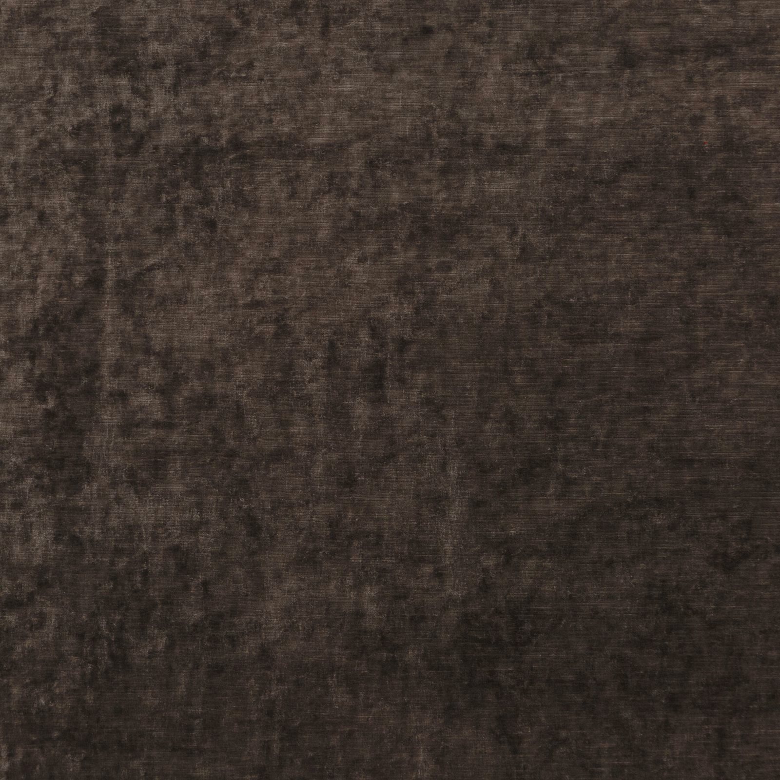 Close-up of dark mole brown velvet with charcoal mottling and a plush sheen