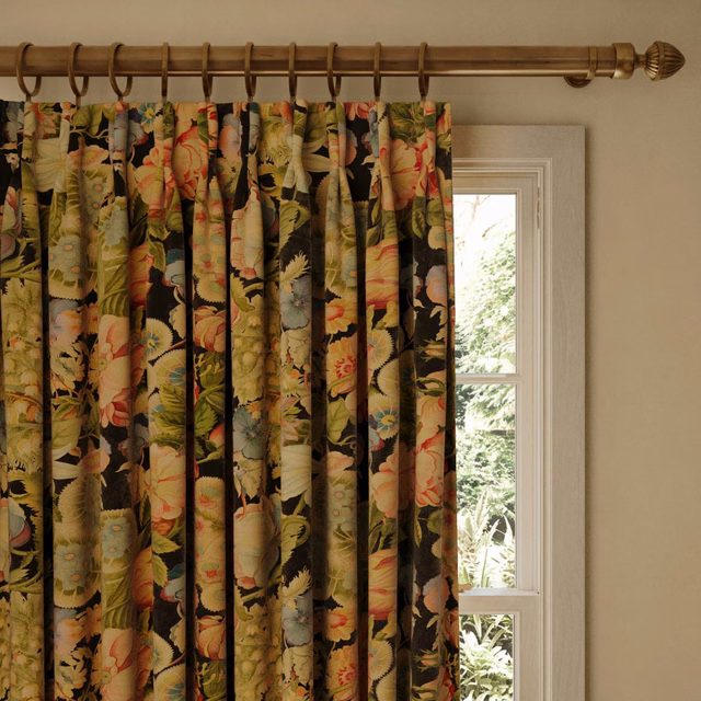 Near-black velvet curtain with coral flowers and olive botanical foliage