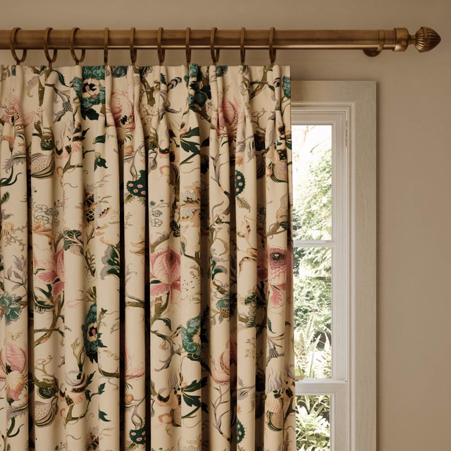 Warm off-white curtain with pink blossoms, green leaves and trailing botanical stems