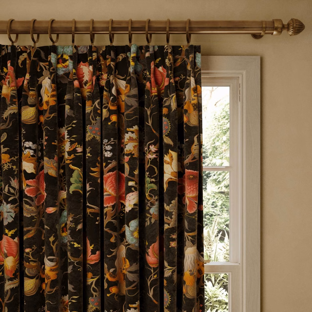 Black velvet curtain with vivid coral, ochre, teal botanical and bird motifs